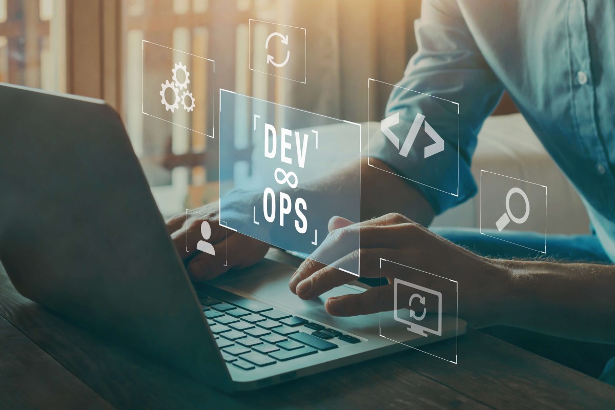 Devops graphic and person working on laptop